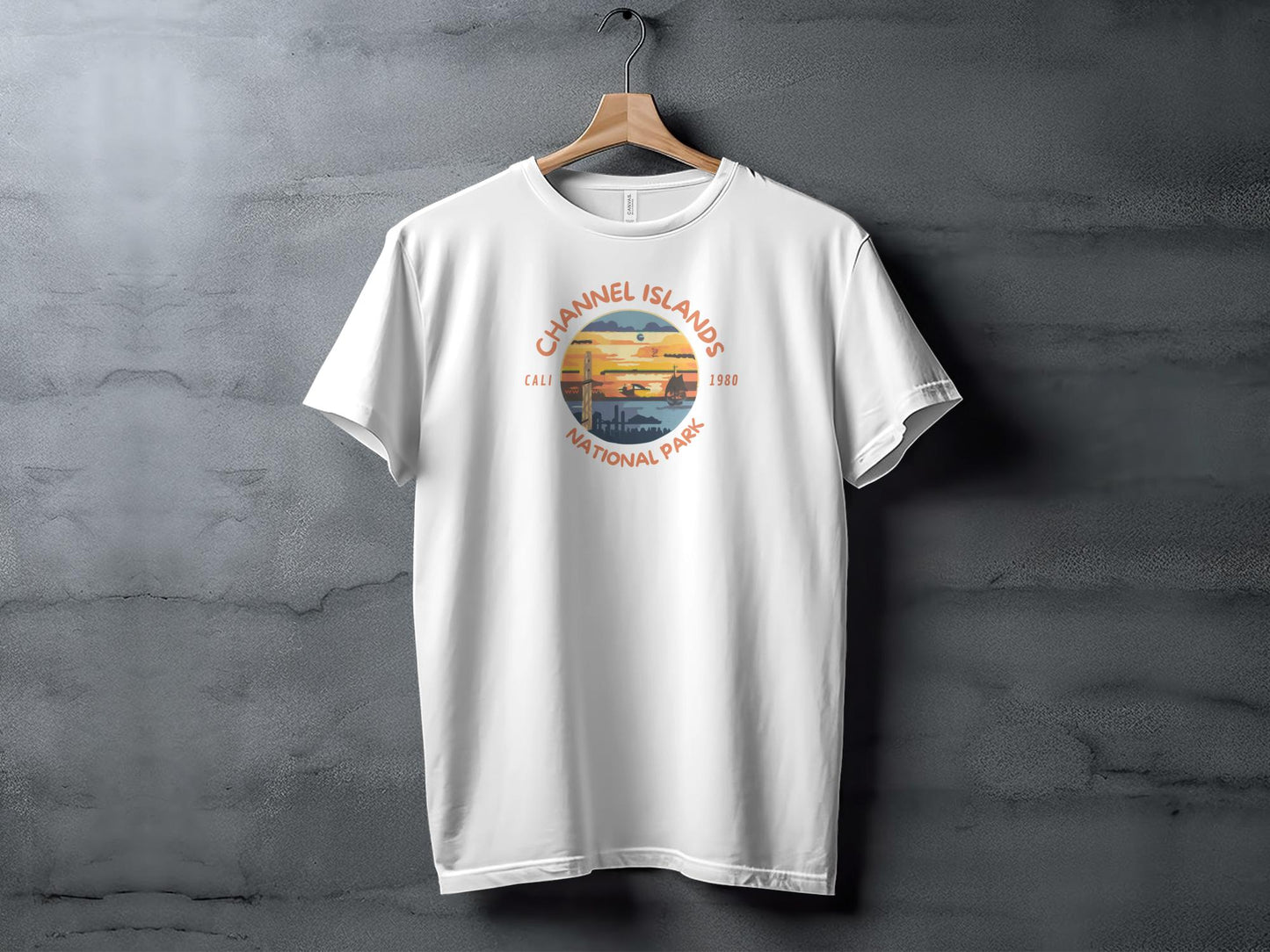 White t-shirt with circular Channel Islands National Park graphic and sunset beach scene.
